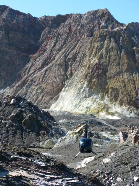 Our Volcanic Air Safaris helicopter parked on White Island surrounded by majestic volcano scenery