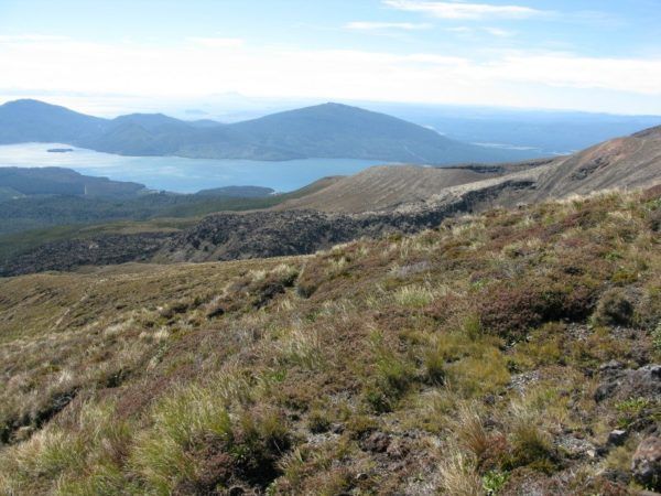 On the way down from the highest part of the Tongariro Alpine Trek, with a lake in the distance