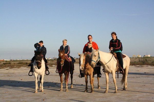 Vesna and Mike and their kids on horses in Galveston