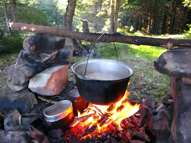 cooking dinner over a campfire in the Carpathian mountains