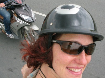 Nora Dunn The Professional Hobo on the back of the bike in Saigon