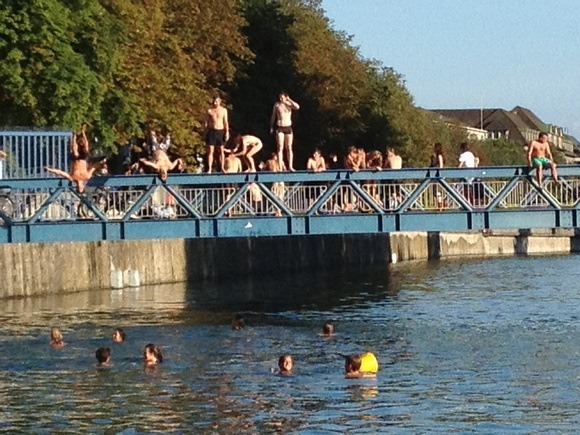 diving in off the bridge into the river in Zurich Switzerland