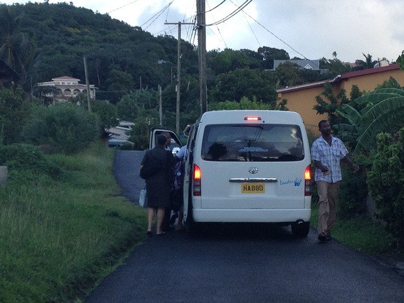 backing down a side road to pick up passengers