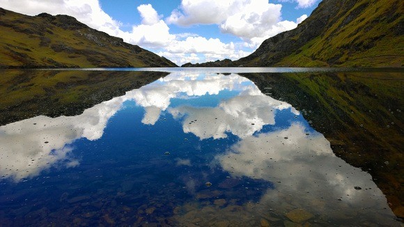 Reflective lake and mountains at Kinsa Cocha Peru