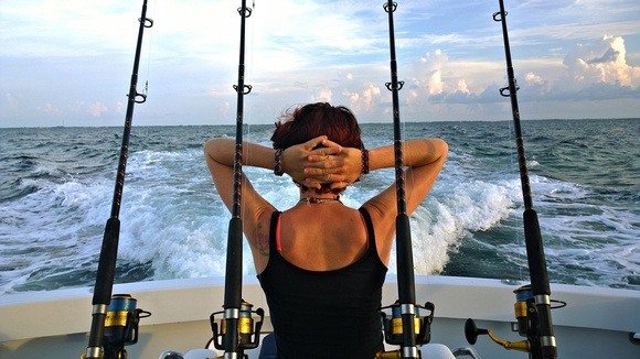 relaxing on a fishing boat with four fishing poles in the Florida Keys