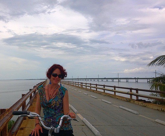 Nora Dunn, The Professional Hobo, on a bicycle by an abandoned bridge road