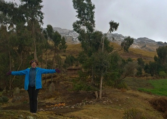 Nora Dunn bundled up near Pachatusan mountain, covered in snow in the distance