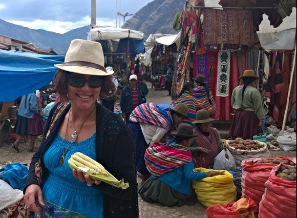 The Professional Hobo, Nora Dunn, at Pisac Market holding choclo con queso