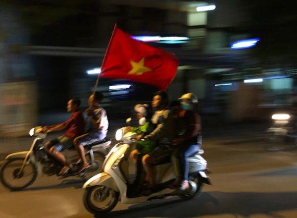 carrying the Vietnamese flag on a motorcycle