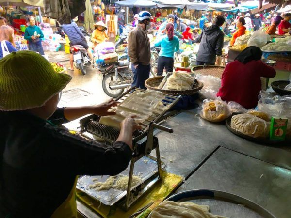 Hoi An market making fresh rice noodles