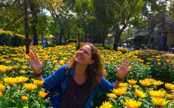 Nora Dunn, The Professional Hobo, enjoying the sunshine with Tet flowers in Hoi An