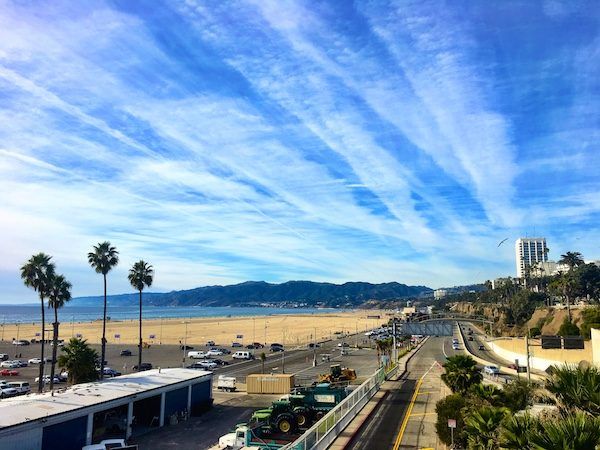 Los Angeles Santa Monica beach with big sky; a home base in LA will cost you! Tricky for financially sustainable travel. Tips on creating a long term travel budget.