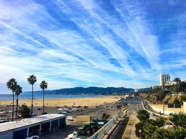 Los Angeles Santa Monica beach with big sky; a home base in LA will cost you! Tricky for financially sustainable travel. Tips on creating a long term travel budget. 