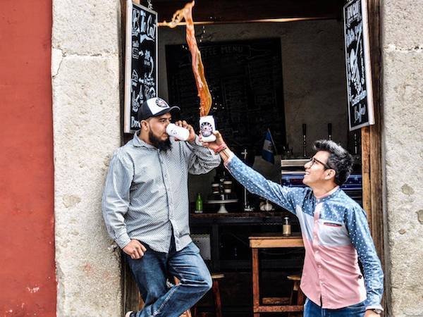 Tossing coffee at Fat Cat Coffee House - one of the best places to have coffee in Antigua Guatemala