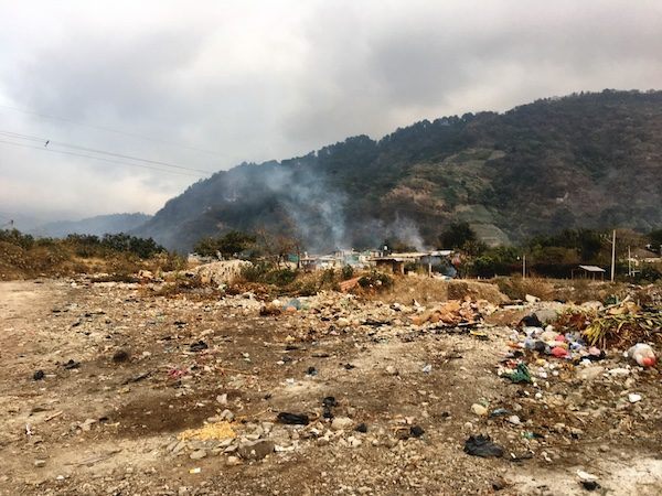Burning garbage on the riverbanks of Panajachel Guatemala. My travel mistake was booking accommodation in the wrong place. 