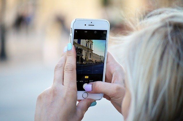 Woman Taking a Smartphone Picture - Options for Unlocked International Cell Phones