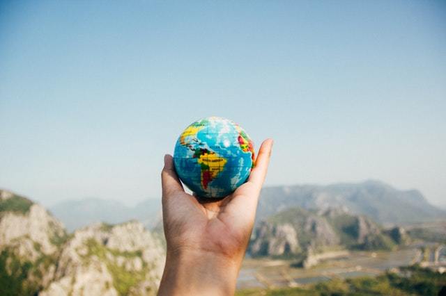 a globe in the palm of a hand, how to travel full-time