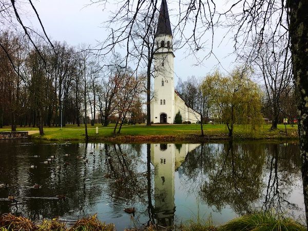 Charming Sigulda Latvia, church reflected in a pond - Things to do in Latvia