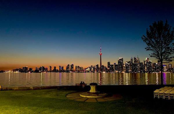 Toronto downtown lit up at sunset, with Lake Ontario in front