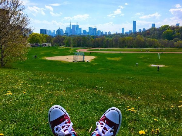 summer in Toronto, overlooking green baseball field with downtown city buildings in the background