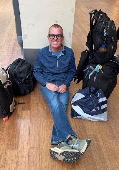 Matt Wald wearing his trusty jeans and HOKAs on a travel day