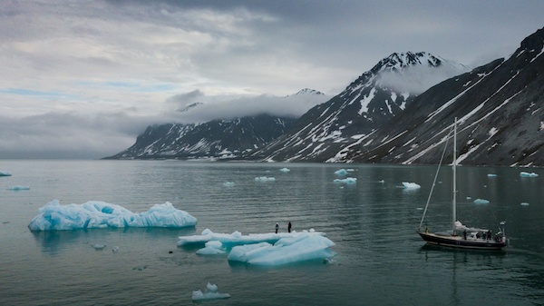 Sailing around Svalbard, standing on an iceberg